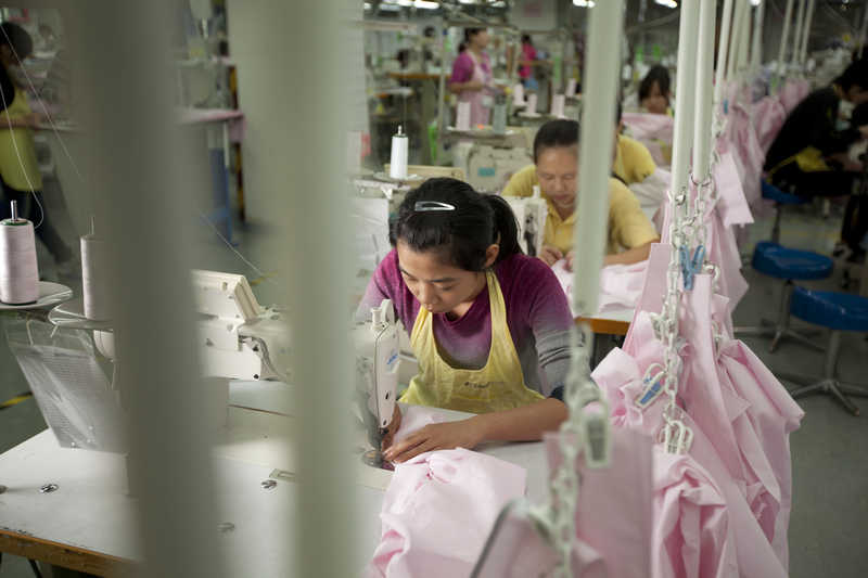 Workers assemble shirts at the Lever Style factory in Shenzhen