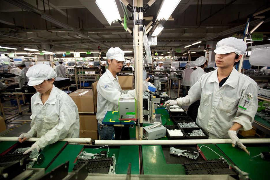 Workers assemble computer printers at Hon Hai's Shenzhen campus