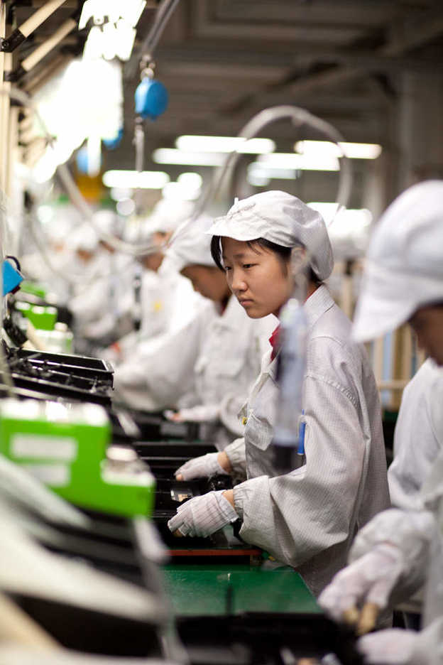 Workers assemble electronics at Hon Hai's Shenzhen campus