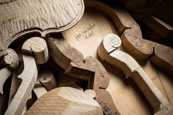 Parts of unfinished violins are arranged for photography at Jan Majersky's home workshop