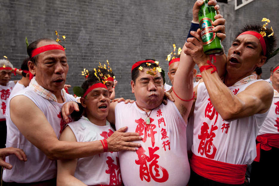 Drunken Dragon festival participants brace themselves to keep from falling