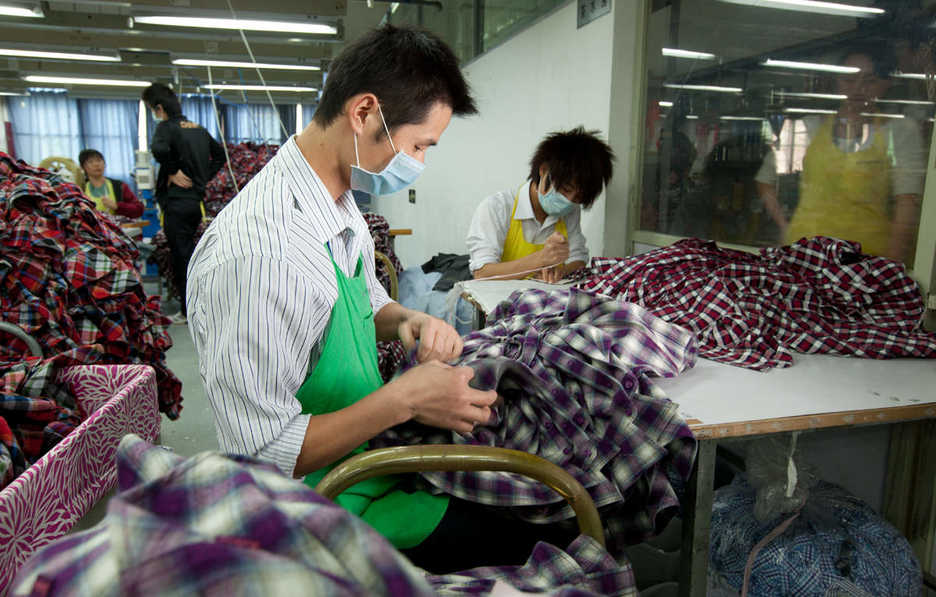 Workers process shirts at the Lever Style factory in Guan Lan, Shenzhen, China