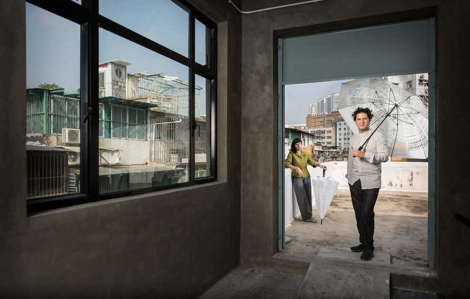 Manuel CS and Clara Brito pose on the roof of their studio building in Macau, China