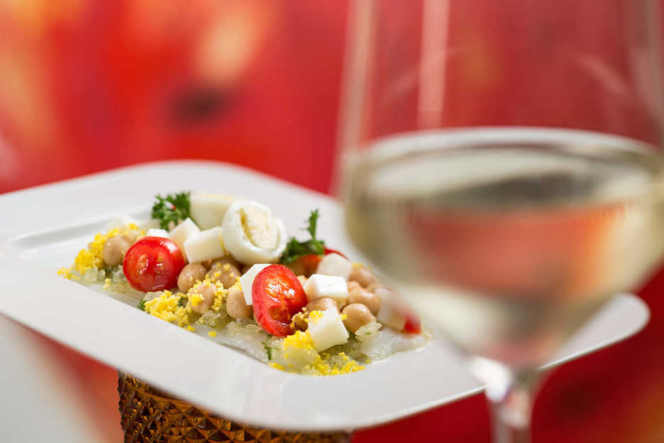 A tomato and cheese dish with wine at Fado restaurant in Macau