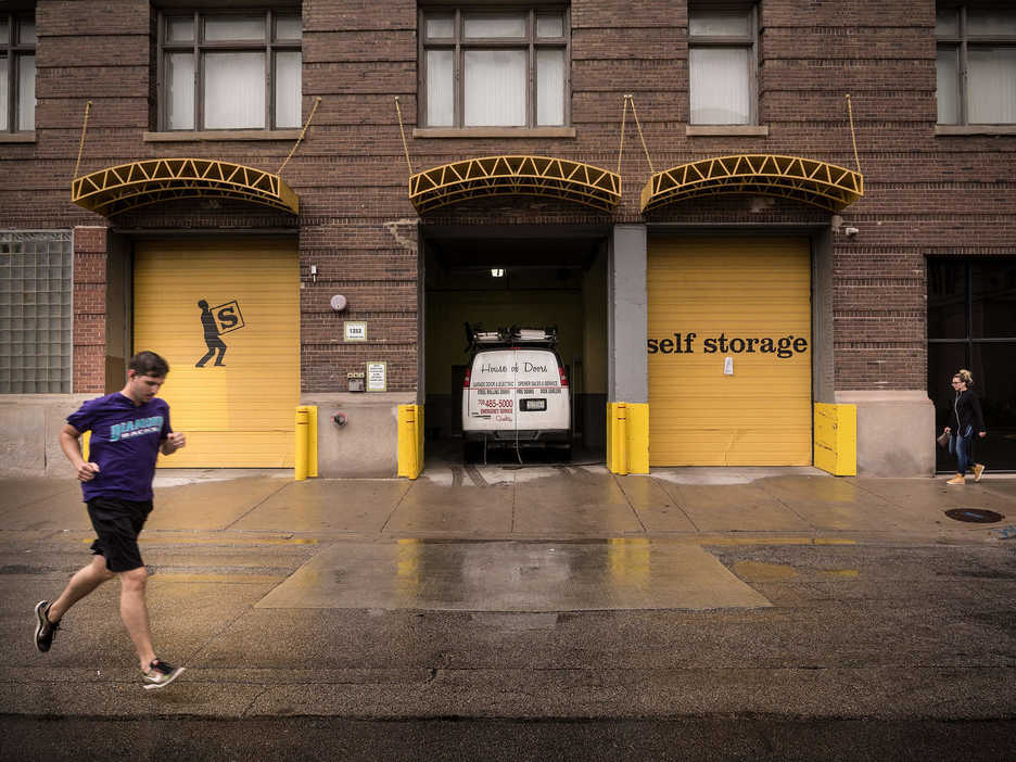 People walk past a storage facility in Chicago